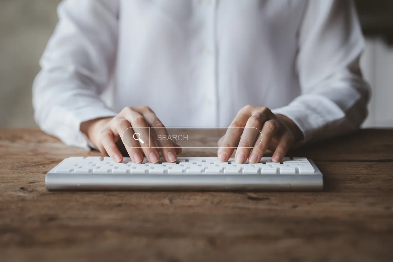 a person who is typing on a hologram search box