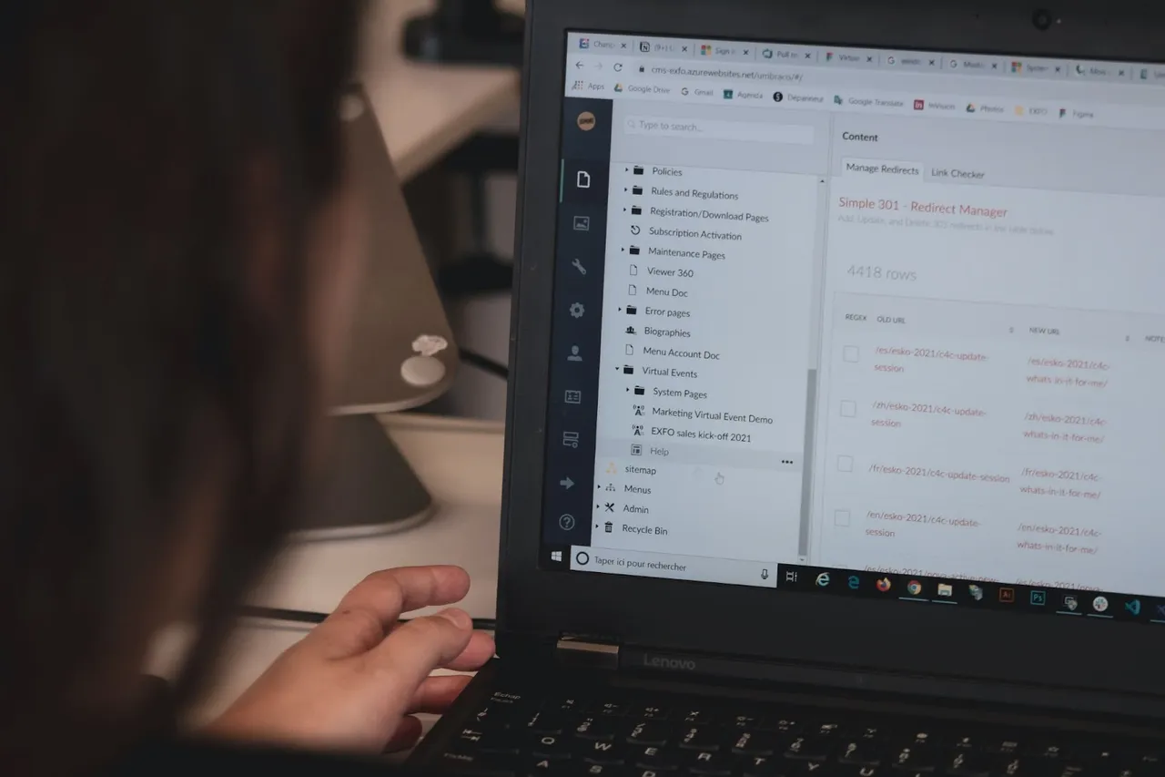 A CMS dashboard on the laptop and a person managing it